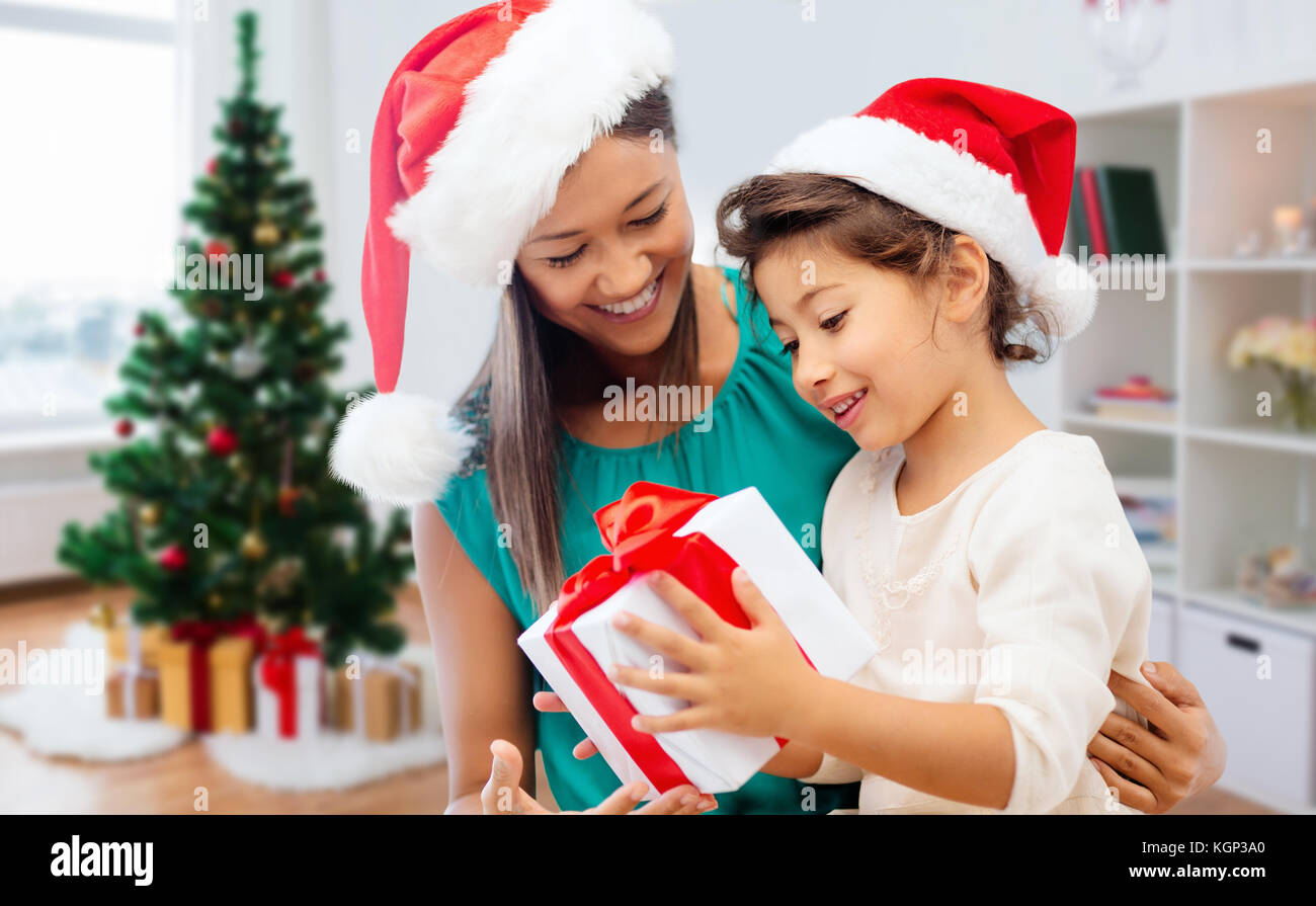 Happy mother and daughter with Christmas gift