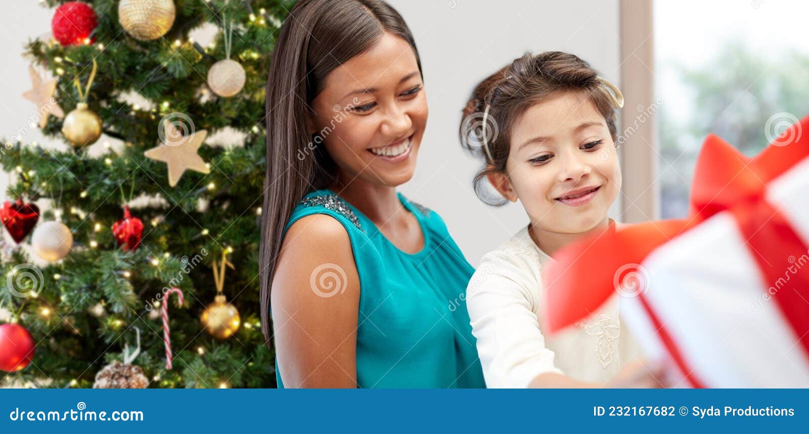 Happy mother and daughter with Christmas gift